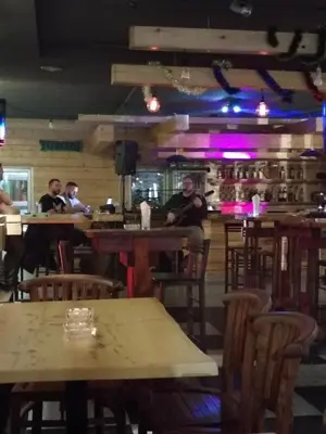 a group of people sitting at tables in a restaurant at Etno kuca Brzece in Brzeće