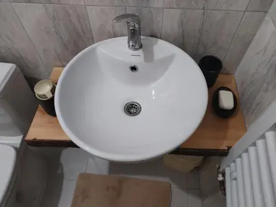 a white sink in a bathroom with a toilet at Etno kuca Brzece in Brzeće
