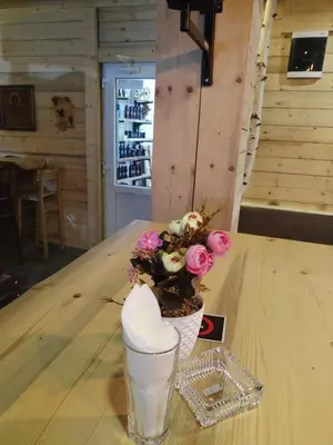 a vase with flowers sitting on a table at Etno kuca Brzece in Brzeće