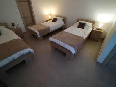 two beds in a room with two tables and two lamps at Etno kuca Brzece in Brzeće
