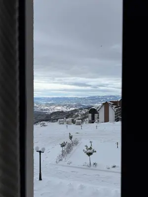 a view from a window of a snow covered field at RASH Apartman in Kopaonik