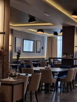 a restaurant with tables and chairs in a room at RASH Apartman in Kopaonik