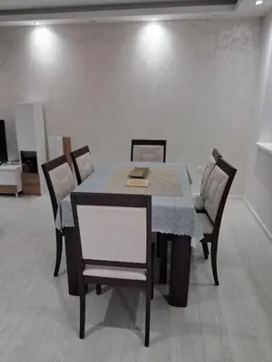a dining room table and chairs in a room at Onix 1 in Soko Banja