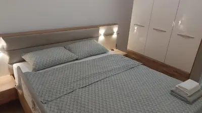 a bedroom with a bed and a cabinet at Onix 1 in Soko Banja