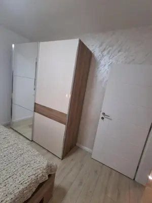 a bedroom with a white closet and a door at Onix 1 in Soko Banja