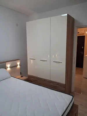 a bedroom with a large white cabinet with lights on it at Onix 1 in Soko Banja