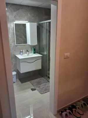 a bathroom with a shower and a sink and a mirror at Onix 1 in Soko Banja