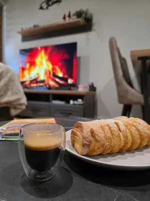 a plate with a cup of coffee and a loaf of bread at Bela Reka 204 in Brzeće