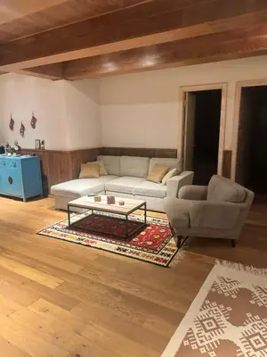 a living room with a couch and a coffee table at Top Hill - Župa Kopaonik in Kopaonik