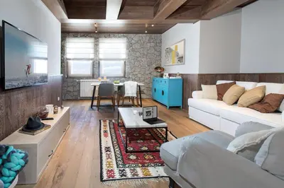 a living room with a couch and a table at Top Hill - Župa Kopaonik in Kopaonik