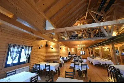a dining room with tables and chairs in a building at Top Hill - Župa Kopaonik in Kopaonik