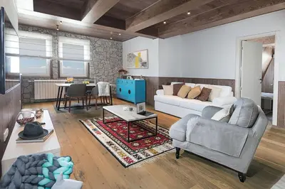 a living room with a couch and a table at Top Hill - Župa Kopaonik in Kopaonik