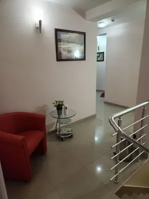 a living room with a red chair and a glass table at Motel Aleksandar in Pojate