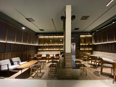 a restaurant with wooden walls and tables and chairs at Apart-Hotel Bela Reka in Brzeće