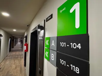 a sign on the wall of a hospital hallway at Apart-Hotel Bela Reka in Brzeće