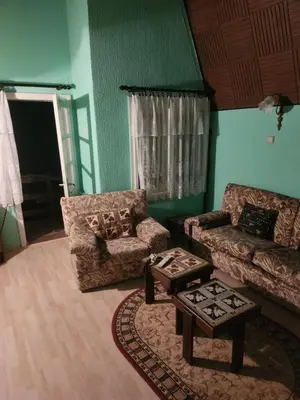 a living room with two couches and a coffee table at Vila Vera Jastrebac in Buci