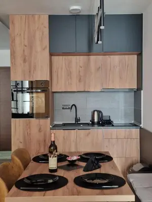 a kitchen with a table with a bottle of wine at SkyLux Apartments Kopaonik - Residence Hill in Kopaonik