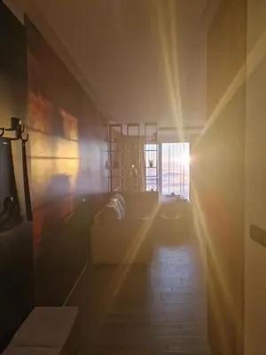 a living room with a couch and a window at SkyLux Apartments Kopaonik - Residence Hill in Kopaonik