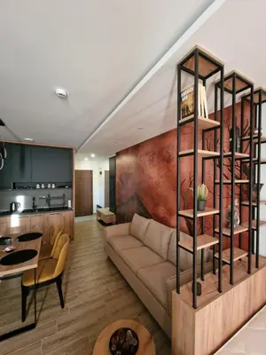 a living room with a couch and a kitchen at SkyLux Apartments Kopaonik - Residence Hill in Kopaonik