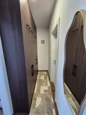a hallway with two stalls and a mirror at Avram in Vrnjci