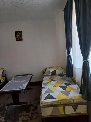 a small bedroom with a bed and a window at Vila Kruna