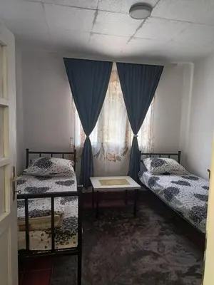a room with two beds and a window at Vila Kruna
