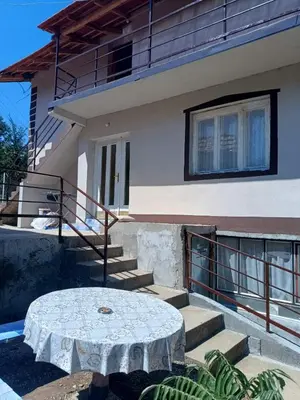 a white table in front of a house at Vila Kruna