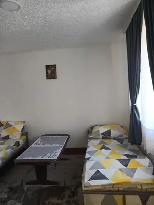 a small room with a bed and a table at Vila Kruna