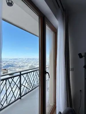 a room with a large glass window with a view at Mountain Hut Kopaonik in Kopaonik