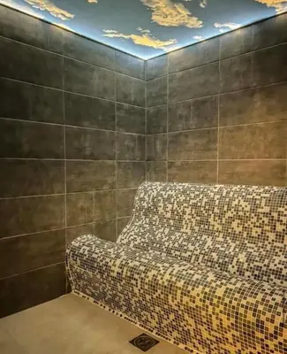 a couch sitting in a room with a wall at Mountain Hut Kopaonik in Kopaonik