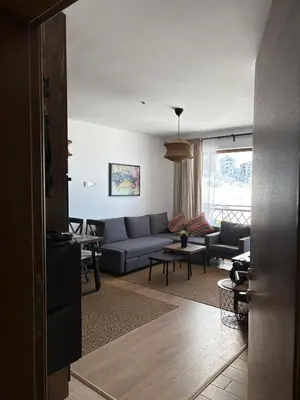 a living room with a couch and a table at Mountain Hut Kopaonik in Kopaonik