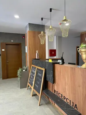 a restaurant with a reception desk with a chalkboard at Mountain Hut Kopaonik in Kopaonik