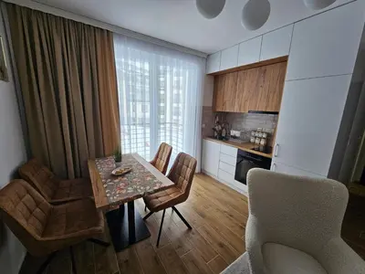 a kitchen and dining room with a table and chairs at Winter Tale in Kopaonik