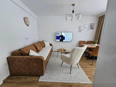 a living room with a brown couch and a table at Winter Tale in Kopaonik