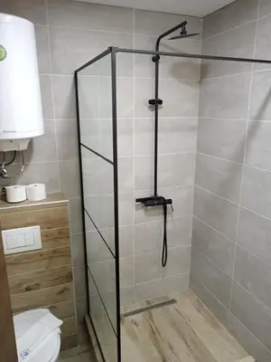 a shower stall in a bathroom with a toilet at Pogled sa oblaka -- View from the clouds in Kopaonik