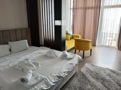 a bedroom with a bed with towels on it at Pogled sa oblaka -- View from the clouds in Kopaonik