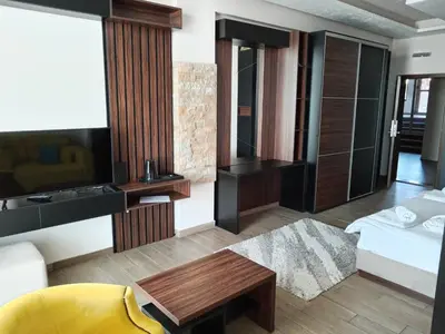 a living room with a bed and a table at Pogled sa oblaka -- View from the clouds in Kopaonik