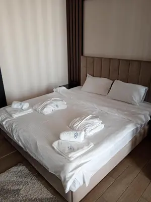 a bed with white towels on top of it at Pogled sa oblaka -- View from the clouds in Kopaonik