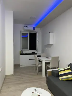 a living room with a couch and a table at Saška Apartments in Niš