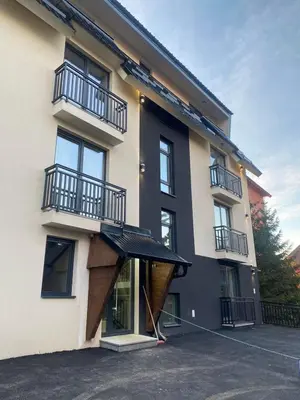 a building with a black awning in front of it at ChiaraKop in Kopaonik