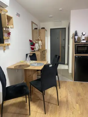 a kitchen with a table and chairs in a room at ChiaraKop in Kopaonik