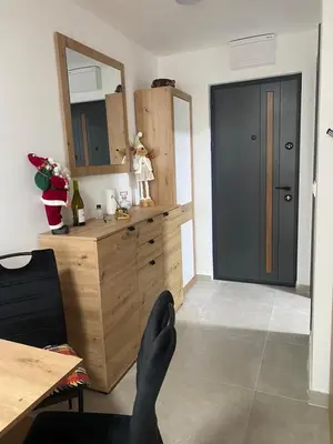 a room with a wooden dresser and a mirror at ChiaraKop in Kopaonik