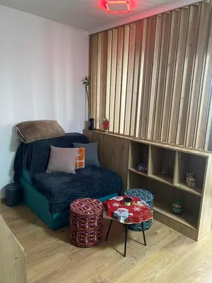 a living room with a couch and a table at ChiaraKop in Kopaonik