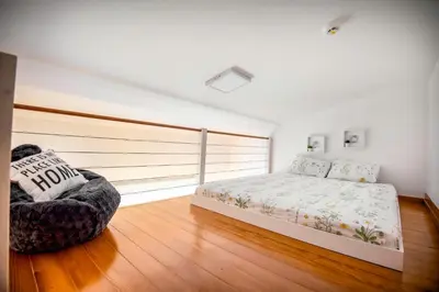 a bedroom with a bed and a chair at Apartman B24 Vidik Residence in Kopaonik
