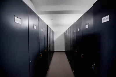 a hallway with black lockers in a building at Apartman B24 Vidik Residence in Kopaonik