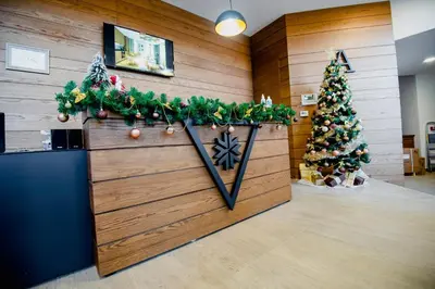 a lobby with two christmas trees on the wall at Apartman B24 Vidik Residence in Kopaonik