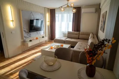 a living room with a couch and a table at Nedodjija apartman in Leskovac