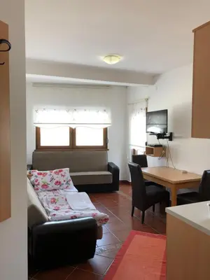 a living room with a couch and a table at Vila Nina Kopaonik in Kopaonik
