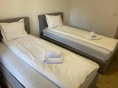 two beds with towels and hats on them in a room at Vila Nina Kopaonik in Kopaonik
