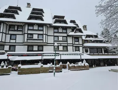 a building covered in snow with a lot of snow at Celestis Apartmani Konaci in Kopaonik